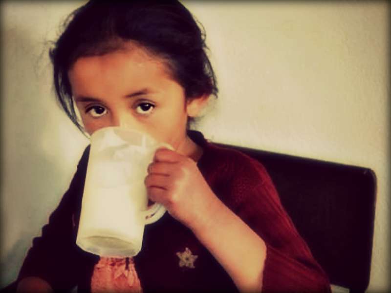 A young Guatemalan girl drinks what is most likely her only meal of the day, a glass of porridge. Photos by Mandi Burgess